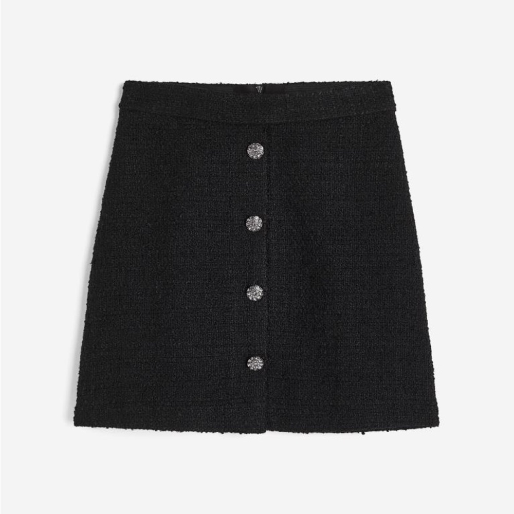 Short, A-line skirt in woven, textured fabric. High